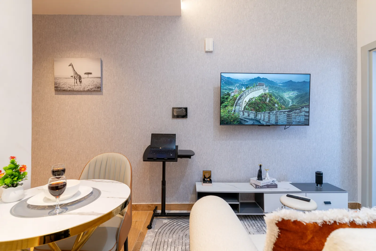 Smart television, laptop stand and dining table in the furnished living room