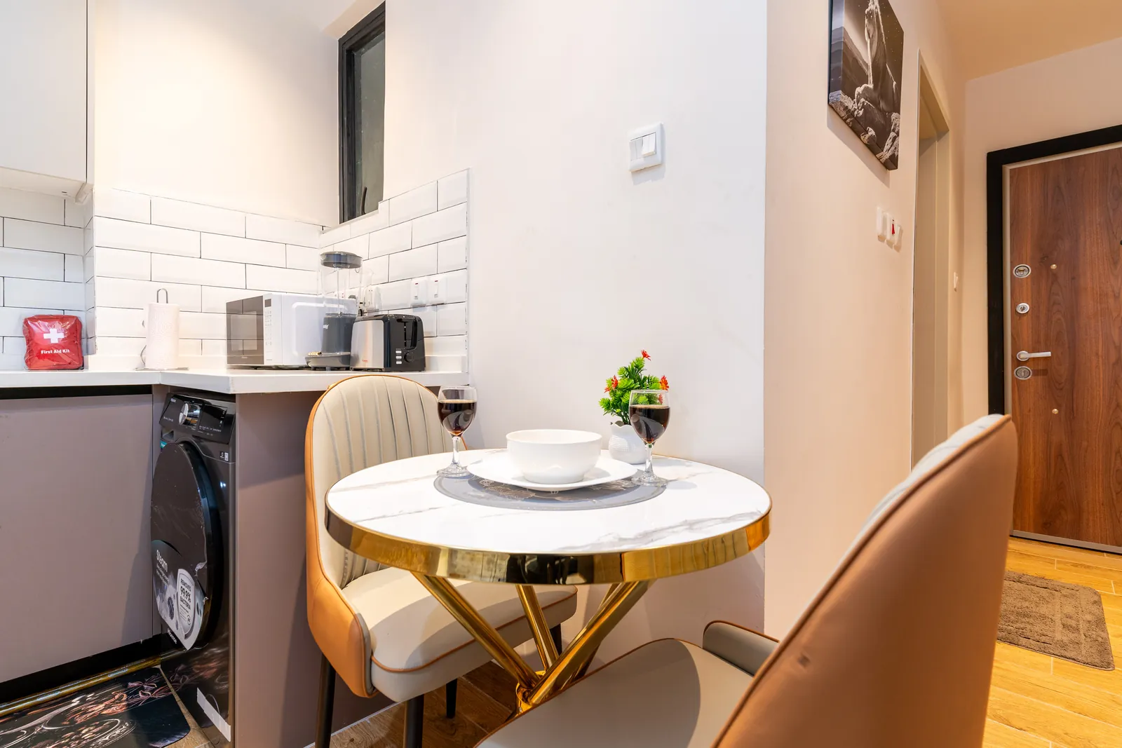 Round dining table and chairs beside the equipped kitchenette