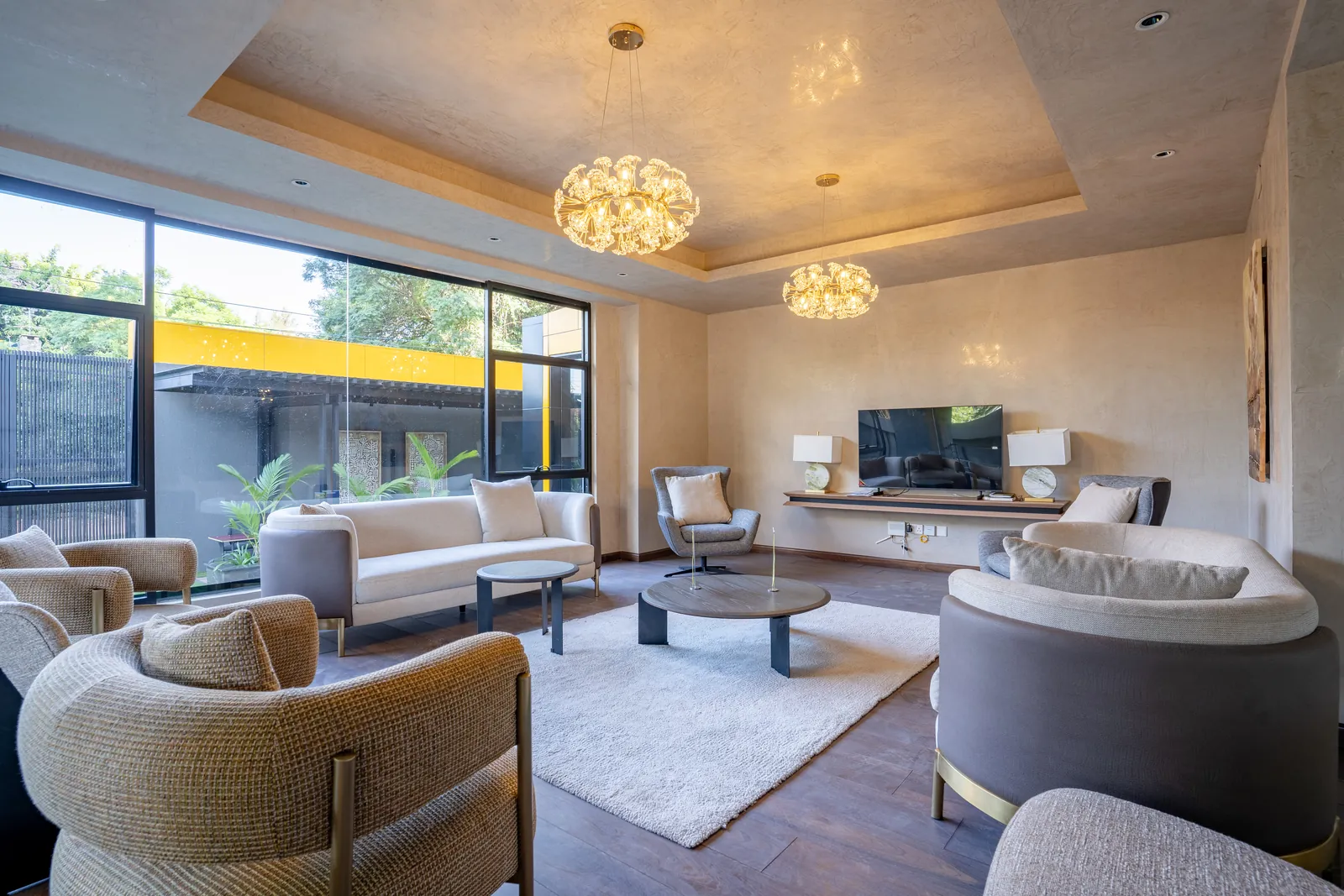 Residents’ lounge with sofas, armchairs, chandeliers and a television