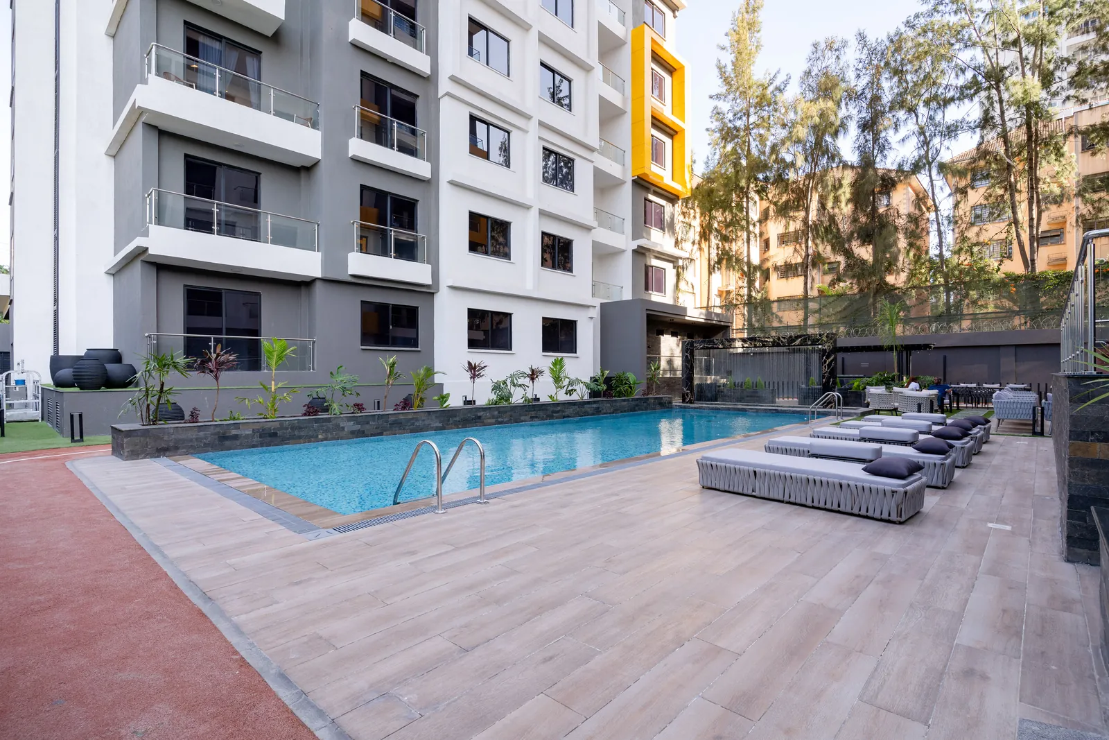 Swimming pool and sun loungers in the Wilma Towers courtyard