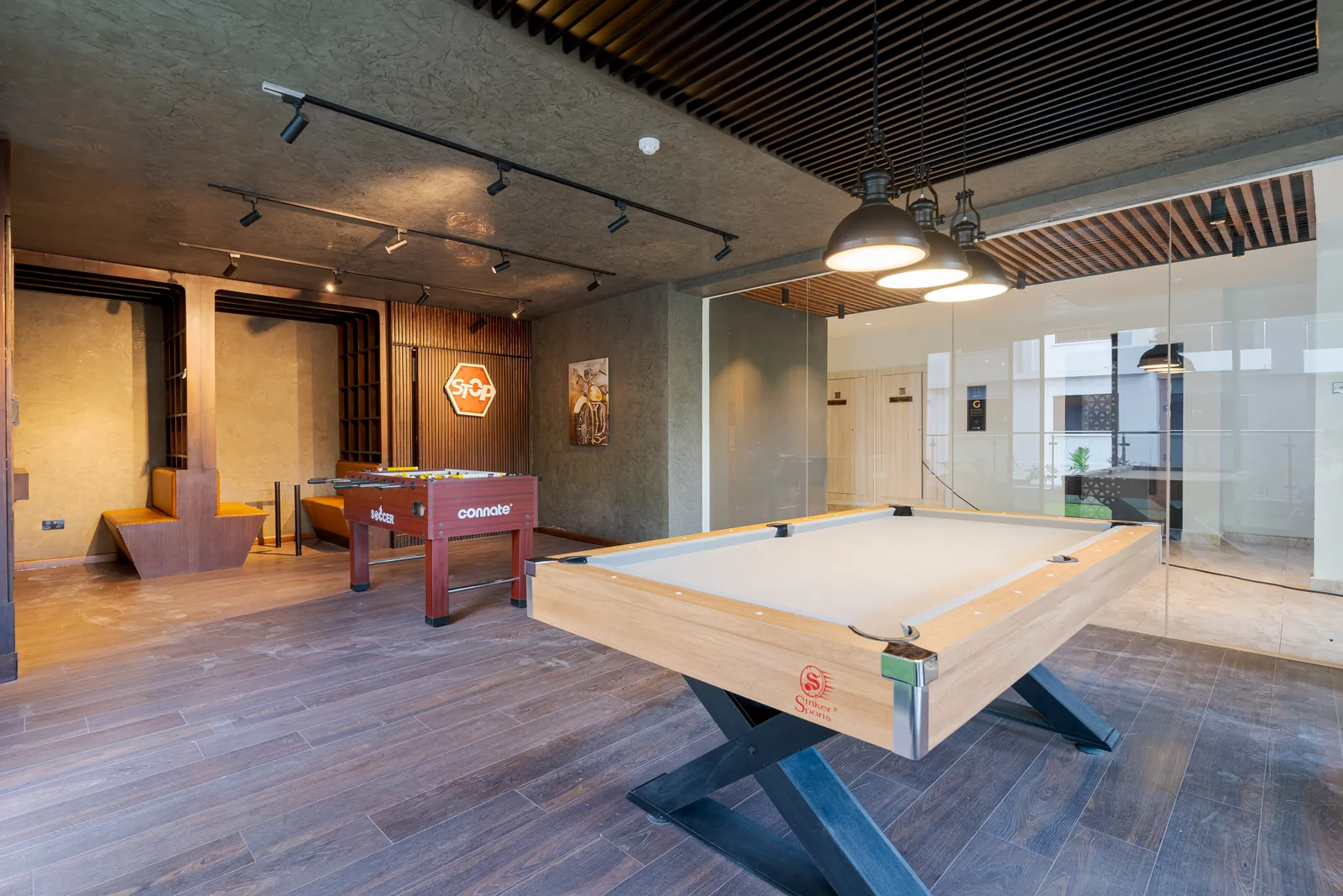 Pool table, table football and seating in the shared games room